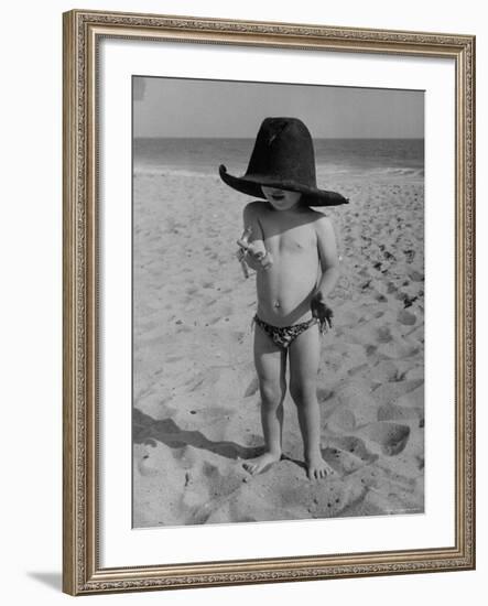 Little Boy at the Beach Wearing a Oversized Cowboy Hat Playing with a Toy Pistol-Ralph Crane-Framed Photographic Print