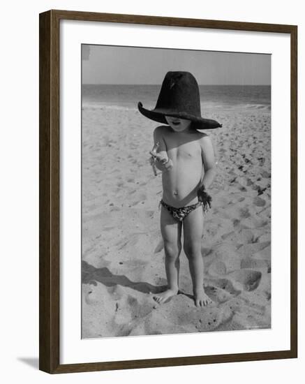 Little Boy at the Beach Wearing a Oversized Cowboy Hat Playing with a Toy Pistol-Ralph Crane-Framed Photographic Print