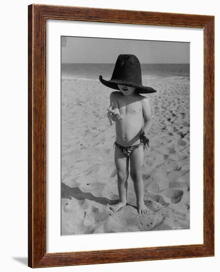 Little Boy at the Beach Wearing a Oversized Cowboy Hat Playing with a Toy Pistol-Ralph Crane-Framed Photographic Print