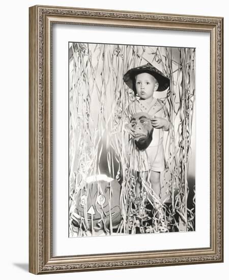 Little Boy in Halloween Costume Holding Mask Standing by Streamers-null-Framed Photo