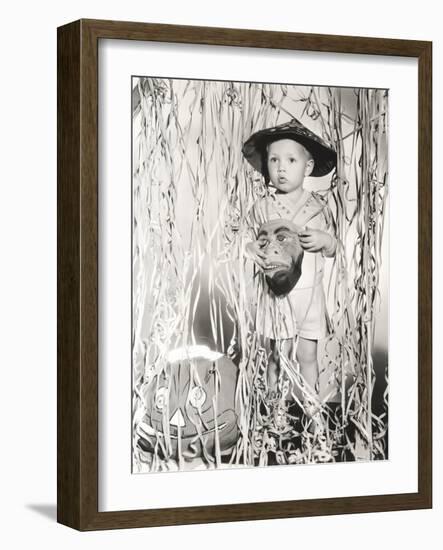 Little Boy in Halloween Costume Holding Mask Standing by Streamers-null-Framed Photo