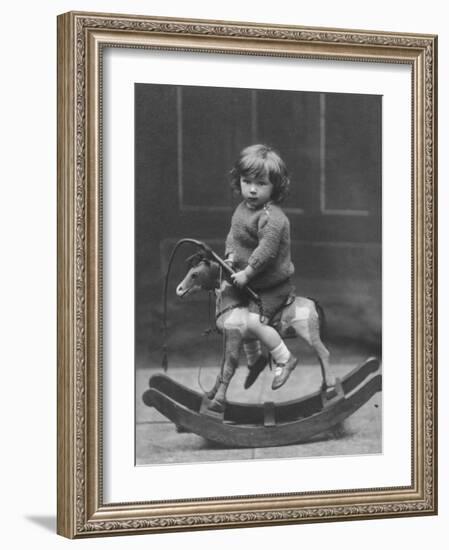 Little Boy on a Very Small Rocking Horse with a Whip in His Hand-null-Framed Photographic Print