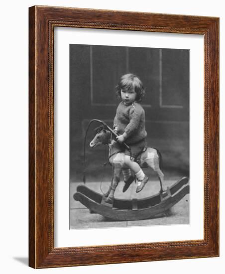 Little Boy on a Very Small Rocking Horse with a Whip in His Hand-null-Framed Photographic Print