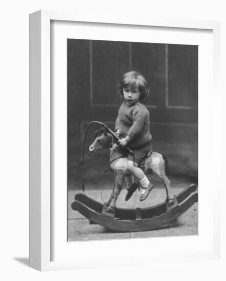 Little Boy on a Very Small Rocking Horse with a Whip in His Hand-null-Framed Photographic Print