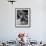 Little Boy on Merry Go Round at the Tuileries Gardens, Sticking Out His Tongue-Alfred Eisenstaedt-Framed Photographic Print displayed on a wall