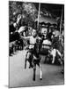 Little Boy on Merry Go Round at the Tuileries Gardens, Sticking Out His Tongue-Alfred Eisenstaedt-Mounted Photographic Print