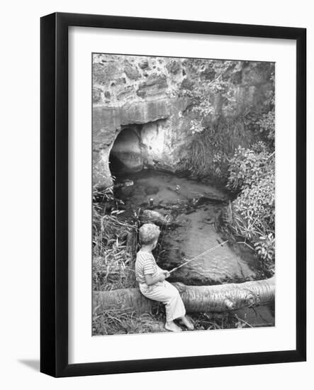 Little Boy Sitting on a Felled Tree, Fishing-Cornell Capa-Framed Photographic Print