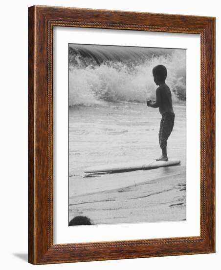 Little Boy Standing on a Surf Board Staring at the Water-Allan Grant-Framed Photographic Print