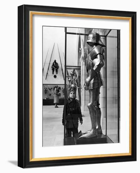 Little Boy Staring Up at Medieval Suit of Armor in the Metropolitan Museum of Art-Alfred Eisenstaedt-Framed Photographic Print