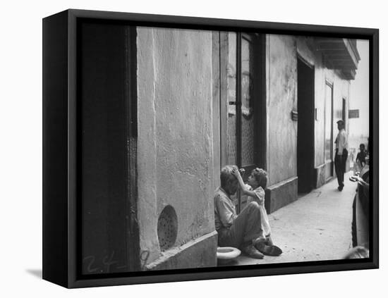 Little Girl Cleaning Face of a Street Beggar-null-Framed Premier Image Canvas