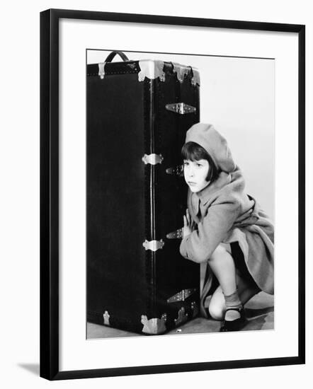 Little Girl in Hat and Coat Crouching Next to a Suitcase-null-Framed Photo