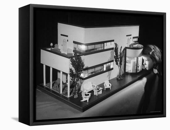 Little Girl Looking Into a Modern Doll House Being Sold at F.A.O. Schwarz-Herbert Gehr-Framed Premier Image Canvas