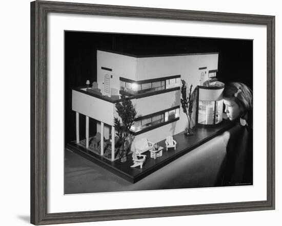 Little Girl Looking Into a Modern Doll House Being Sold at F.A.O. Schwarz-Herbert Gehr-Framed Photographic Print