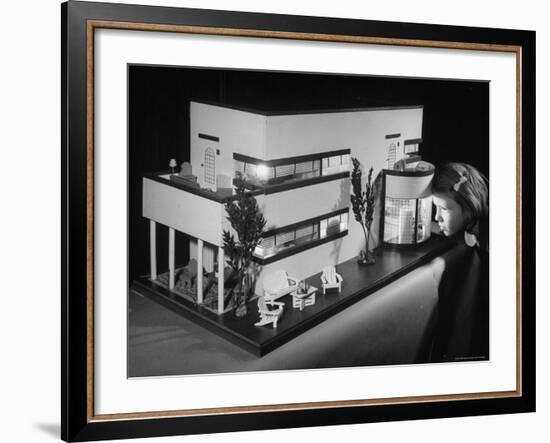 Little Girl Looking Into a Modern Doll House Being Sold at F.A.O. Schwarz-Herbert Gehr-Framed Photographic Print