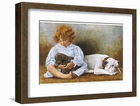 Little Girl Sits with a White Bulldog and Cuddles a Puppy-null-Framed Photographic Print