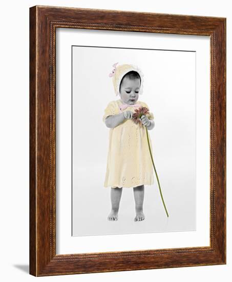 Little Girl Standing Holding a Sunflower-Nora Hernandez-Framed Giclee Print