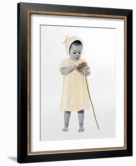 Little Girl Standing Holding a Sunflower-Nora Hernandez-Framed Giclee Print