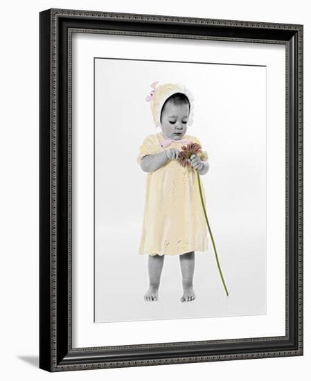 Little Girl Standing Holding a Sunflower-Nora Hernandez-Framed Giclee Print