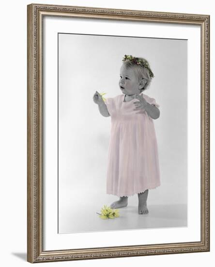 Little Girl Standing with Ring of Flowers on Head Holding Another Flower-Nora Hernandez-Framed Giclee Print