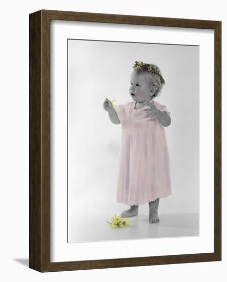 Little Girl Standing with Ring of Flowers on Head Holding Another Flower-Nora Hernandez-Framed Giclee Print