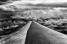 Wing of Airplane Flying in Mid-Air under and Between Clouds-Liyun Yu-Photographic Print