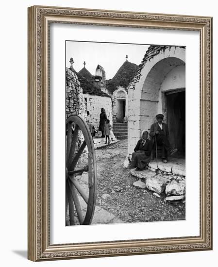 Locals Outside Trulli Homes Made from Limestone Boulders and Feature Conical or Domed Roofs-Alfred Eisenstaedt-Framed Photographic Print