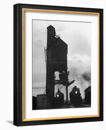 Locomotives Having Their Headlights Cleaned at Dusk-Peter Stackpole-Framed Photographic Print