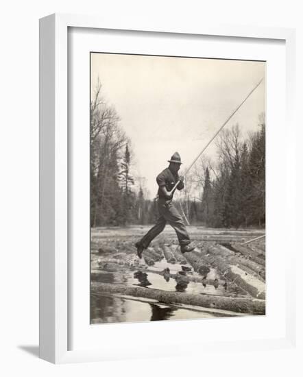 Log Driver Leaping Across Floating Logs to Keep Them Moving by Breaking Loose Any That Get Jammed-Margaret Bourke-White-Framed Photographic Print