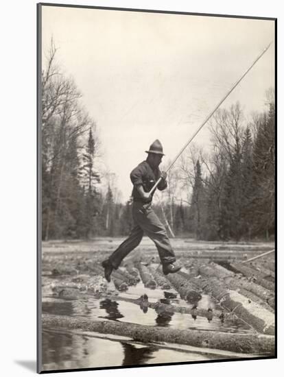 Log Driver Leaping Across Floating Logs to Keep Them Moving by Breaking Loose Any That Get Jammed-Margaret Bourke-White-Mounted Photographic Print