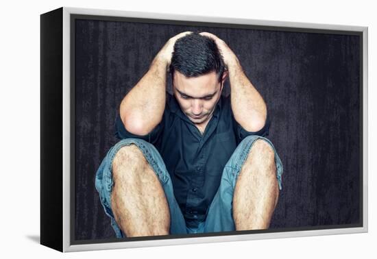 Lonely and Sad Young Man Sitting on the Floor with His Head between His Hands-Kamira-Framed Premier Image Canvas