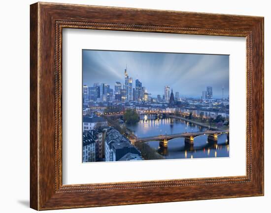 Long exposure of clouds at dusk over the illuminated city skyline and Ignatz Bubis bridge-Roberto Moiola-Framed Photographic Print