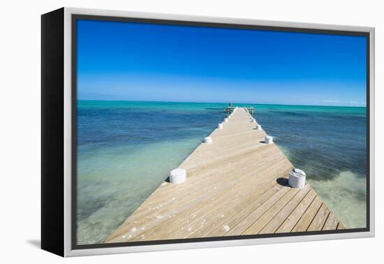 Long wooden pier in the turquoise waters of Providenciales, Turks and Caicos, Caribbean-Michael Runkel-Framed Premier Image Canvas