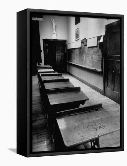 Looking Down Row of Empty Scarred Old Fashioned Desks in Schoolroom-Walter Sanders-Framed Premier Image Canvas