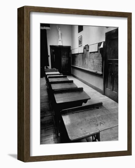 Looking Down Row of Empty Scarred Old Fashioned Desks in Schoolroom-Walter Sanders-Framed Photographic Print