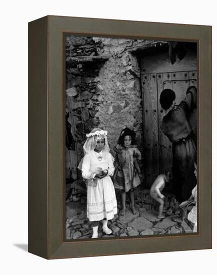 Lorenza Curiel in White First Communion Dress Waiting for Mother to Lock Door-W^ Eugene Smith-Framed Premier Image Canvas