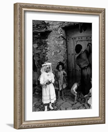 Lorenza Curiel in White First Communion Dress Waiting for Mother to Lock Door-W^ Eugene Smith-Framed Photographic Print