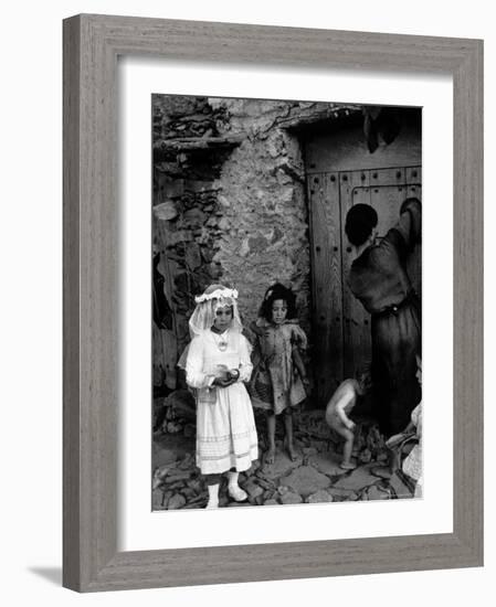 Lorenza Curiel in White First Communion Dress Waiting for Mother to Lock Door-W^ Eugene Smith-Framed Photographic Print