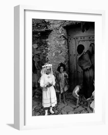 Lorenza Curiel in White First Communion Dress Waiting for Mother to Lock Door-W^ Eugene Smith-Framed Photographic Print