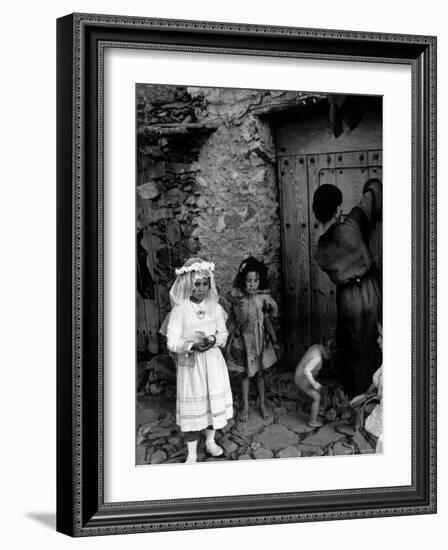 Lorenza Curiel in White First Communion Dress Waiting for Mother to Lock Door-W^ Eugene Smith-Framed Photographic Print