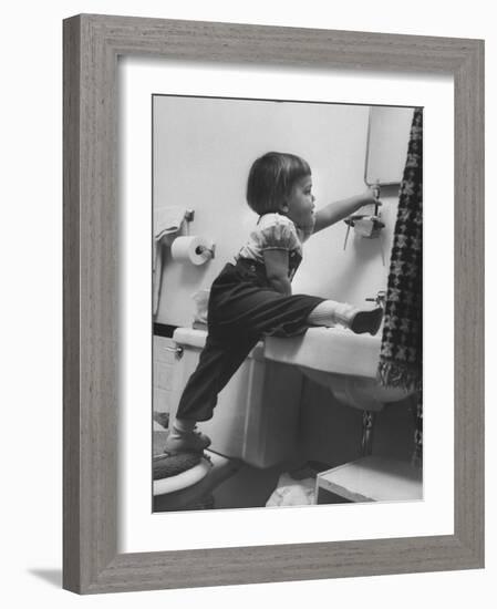 Lori Mckone in Bathroom Reaching for Toothbrush-null-Framed Photographic Print