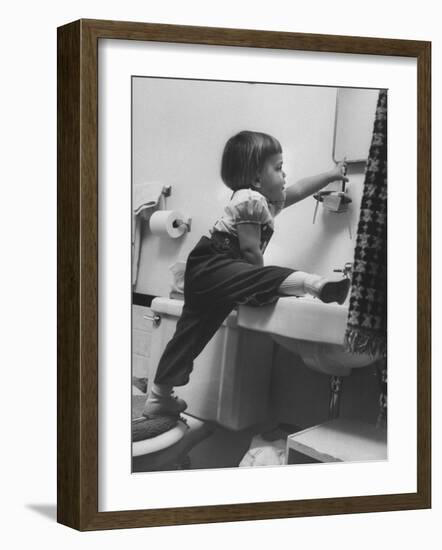 Lori Mckone in Bathroom Reaching for Toothbrush-null-Framed Photographic Print