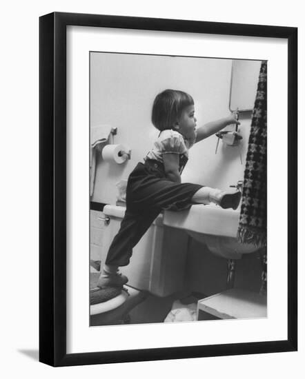 Lori Mckone in Bathroom Reaching for Toothbrush-null-Framed Photographic Print