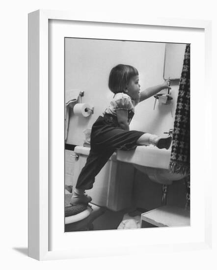 Lori Mckone in Bathroom Reaching for Toothbrush-null-Framed Photographic Print