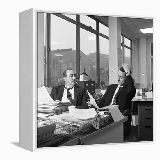 Lost Order? Two Salesmen Try to Sort Out the Orders over a Cigarette, 1967-Michael Walters-Framed Premier Image Canvas