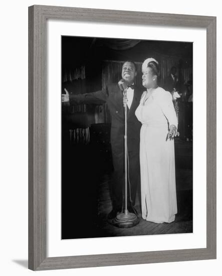 Louis Armstrong and Vocalist Performing in Floor Show at Cafe Zanzibar-Alfred Eisenstaedt-Framed Premium Photographic Print