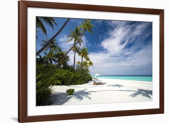 Lounge chairs under shade of umbrella on tropical beach, Maldives, Indian Ocean, Asia-Sakis Papadopoulos-Framed Photographic Print