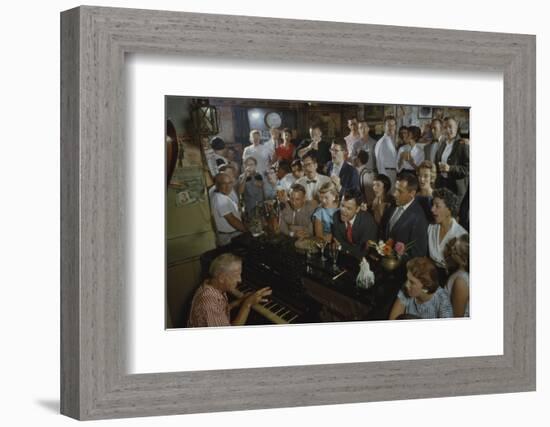 Low-Angle View of a Group of People as They Sing Along with a Pianist in a Unidentified Bar, 1959-Yale Joel-Framed Photographic Print