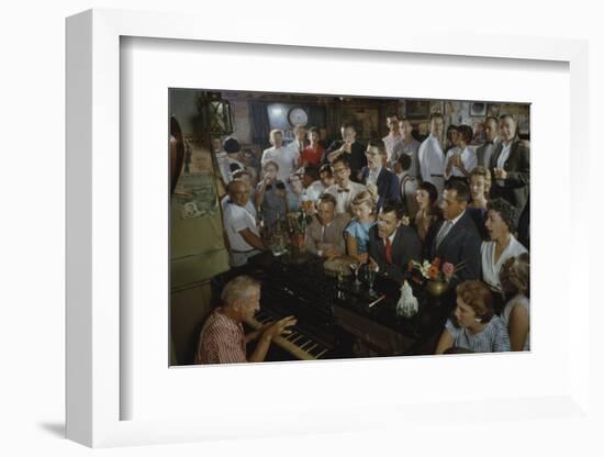 Low-Angle View of a Group of People as They Sing Along with a Pianist in a Unidentified Bar, 1959-Yale Joel-Framed Photographic Print