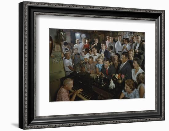 Low-Angle View of a Group of People as They Sing Along with a Pianist in a Unidentified Bar, 1959-Yale Joel-Framed Photographic Print