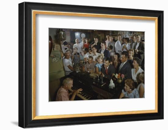 Low-Angle View of a Group of People as They Sing Along with a Pianist in a Unidentified Bar, 1959-Yale Joel-Framed Photographic Print